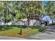 Beautifully landscaped front yard, mailbox, driveway and classic one-story home with charming architectural details at 24 Cypress Ave, St Cloud, FL 34769