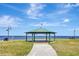 Picturesque gazebo with an American flag, offering serene waterfront views and a tranquil setting at 24 Cypress Ave, St Cloud, FL 34769