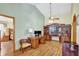 Well-appointed home office with a wooden desk, built-in shelves, and ample natural light at 24 Cypress Ave, St Cloud, FL 34769