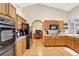 Spacious kitchen featuring light wood cabinets, modern appliances, and an open layout leading to other living areas at 24 Cypress Ave, St Cloud, FL 34769