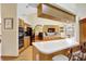 Open kitchen with light wood cabinetry, ample counter space, and modern appliances, offering a functional design at 24 Cypress Ave, St Cloud, FL 34769