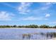 Beautiful lake view highlighting waterfront scenery, trees and calm waters for peaceful living at 24 Cypress Ave, St Cloud, FL 34769
