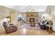 Cozy living room with a stone fireplace, comfortable seating, and a decorative rug at 24 Cypress Ave, St Cloud, FL 34769