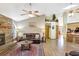 Open living area with a stone fireplace, ceiling fans, and a view into the kitchen at 24 Cypress Ave, St Cloud, FL 34769