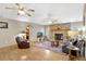 Inviting living room featuring a stone fireplace, ceiling fans, and comfortable seating at 24 Cypress Ave, St Cloud, FL 34769