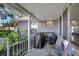 Inviting screened-in porch perfect for relaxing outdoors with comfortable seating and a barbecue grill at 24 Cypress Ave, St Cloud, FL 34769