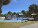 Fun splash pad area with colorful features for children, surrounded by shady palm trees at 24 Cypress Ave, St Cloud, FL 34769