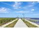 View of walking path through the park, leading to the lake and a covered gazebo at 24 Cypress Ave, St Cloud, FL 34769