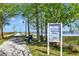 Paver path along the lake with a view of 'Dan Tarrell Memorial Point' sign at 24 Cypress Ave, St Cloud, FL 34769