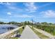 Paved walkway alongside a lake, perfect for leisurely strolls with scenic water and building views at 24 Cypress Ave, St Cloud, FL 34769