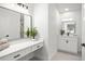 Bright, modern bathroom with double vanity, ample counter space, and a decorative plant at 2555 Sweetwater Trl, Maitland, FL 32751