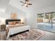 Bright bedroom features a ceiling fan and sliding glass doors leading to the pool area at 2555 Sweetwater Trl, Maitland, FL 32751
