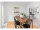 Bright dining area with a wooden table, black chairs, and a view of the modern stainless steel refrigerator at 2555 Sweetwater Trl, Maitland, FL 32751
