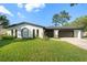 Charming single-story home with a well-manicured lawn and attached two-car garage at 2555 Sweetwater Trl, Maitland, FL 32751