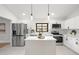 Bright kitchen with white cabinetry, stainless steel appliances, and center island, perfect for cooking and entertaining at 2555 Sweetwater Trl, Maitland, FL 32751