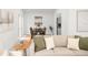 Bright living room flows seamlessly into the dining area, featuring a comfortable sofa and stylish decor at 2555 Sweetwater Trl, Maitland, FL 32751
