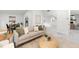 Bright living room with modern decor, including a plush sofa, stylish rug, and wood-look flooring at 2555 Sweetwater Trl, Maitland, FL 32751