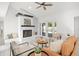 Bright living room with a cozy fireplace, modern seating, and access to the outdoor pool area at 2555 Sweetwater Trl, Maitland, FL 32751