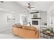 Bright living room with a cozy fireplace and view to other rooms at 2555 Sweetwater Trl, Maitland, FL 32751