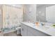 Fresh bathroom with a white vanity, blue accents, and a shower-tub combination at 261 Whistling Duck Trl, St Cloud, FL 34771