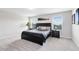 Spacious bedroom features a large bed, two windows, and neutral carpeting at 261 Whistling Duck Trl, St Cloud, FL 34771