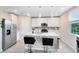 Modern kitchen with white cabinets, stainless steel appliances, and a center island with seating at 261 Whistling Duck Trl, St Cloud, FL 34771