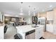 Modern kitchen with white cabinetry, stainless steel appliances, large island and pendant lighting at 261 Whistling Duck Trl, St Cloud, FL 34771
