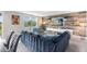 Comfortable living room features a large blue sectional, wood accent wall, and bright natural light at 261 Whistling Duck Trl, St Cloud, FL 34771