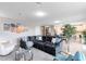 Bright, open-concept living room with stylish decor, tile floors, and plenty of seating at 261 Whistling Duck Trl, St Cloud, FL 34771