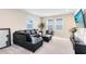 Cozy living room features a comfortable leather couch and neutral carpet at 261 Whistling Duck Trl, St Cloud, FL 34771
