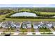 Charming street view of gray two-story homes near a tranquil lake and green landscape at 261 Whistling Duck Trl, St Cloud, FL 34771