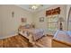 Cozy bedroom with vibrant bedding, hardwood floors, and natural light streaming in from the window at 2954 Willow Bay Ter, Casselberry, FL 32707