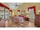 This bright bedroom features hardwood floors, red accents, and a sliding glass door leading to the outside at 2954 Willow Bay Ter, Casselberry, FL 32707