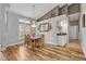 Elegant dining room featuring hardwood floors, a chandelier, and a large window creating a warm and inviting atmosphere at 2954 Willow Bay Ter, Casselberry, FL 32707