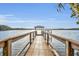 Picturesque dock with wooden railings leading to a gazebo overlooking a serene lake at 2954 Willow Bay Ter, Casselberry, FL 32707