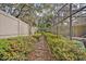 The stone pathway leads through a lush garden with vibrant flowers and privacy fencing, offering a tranquil escape at 2954 Willow Bay Ter, Casselberry, FL 32707
