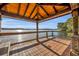 Waterfront gazebo with wooden deck and roof overlooking a scenic lake and lush greenery at 2954 Willow Bay Ter, Casselberry, FL 32707