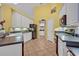 Bright kitchen features white cabinetry, tiled floors, black appliances and a walk-in pantry at 2954 Willow Bay Ter, Casselberry, FL 32707
