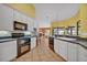 Well-appointed kitchen with tiled flooring, white cabinets, and a view of a breakfast nook adding warmth and functionality at 2954 Willow Bay Ter, Casselberry, FL 32707
