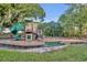 Community playground featuring a slide, swings, climbing structures, and benches at 2954 Willow Bay Ter, Casselberry, FL 32707