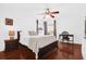 Cozy bedroom with hardwood floors, a ceiling fan, and natural light from the windows at 2991 Timpana Pt, Longwood, FL 32779