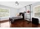 Bright bedroom with hardwood floors, a ceiling fan, and a large window at 2991 Timpana Pt, Longwood, FL 32779