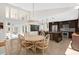 Bright dining area adjacent to the kitchen, featuring a round table, wicker chairs, and a view of the backyard at 2991 Timpana Pt, Longwood, FL 32779