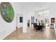 Bright dining room with a large green clock, travertine tile flooring, and tall windows at 2991 Timpana Pt, Longwood, FL 32779