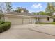 Attached two car garage with extra driveway parking and manicured hedges along the side of the home at 2991 Timpana Pt, Longwood, FL 32779