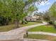 Manicured front yard features a long, curved sidewalk leading up to the front of the home at 2991 Timpana Pt, Longwood, FL 32779
