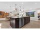 Spacious kitchen featuring granite counters, stainless steel appliances, and a large island, perfect for cooking and entertaining at 2991 Timpana Pt, Longwood, FL 32779