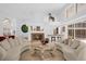Open concept living room with curved sofas, fireplace, and a large, unique piece of artwork at 2991 Timpana Pt, Longwood, FL 32779