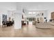 Open concept living room with fireplace, bar, and view of backyard pool and dining room at 2991 Timpana Pt, Longwood, FL 32779
