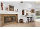 Close-up view of the fireplace with bar seating and a view of the backyard pool at 2991 Timpana Pt, Longwood, FL 32779